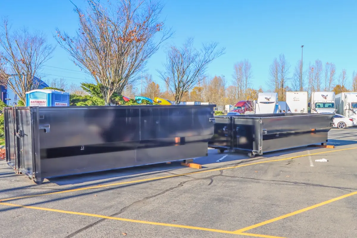 Professional dumpster rental service with roll-off container on residential driveway in Laketon